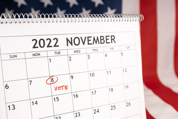 November 2022 America Vote day concept. Desk calendar with November 8 marked in red and USA flag at...