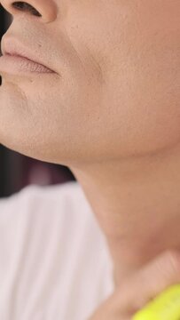 Close-up view of drag queen artist applying foundation on the neck with a makeup brush. Lgbt concept.