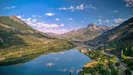 Naklejka na ściany i meble Landscape of a mountain reflected in a lake on a sunny summer morning