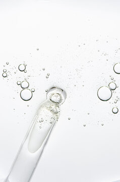 The texture of a cosmetic serum with a pipette closeup. Copy space