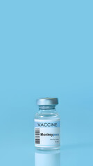 Vial with vaccine Monkeypox on a blue background.The concept of medicine, healthcare and science.Monkeypox is a viral zoonotic disease. Monkeys may harbor the virus and infect people.
