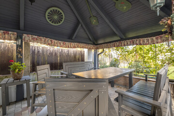 interior of empty hall veranda in wooden village vacation home with garden chairs