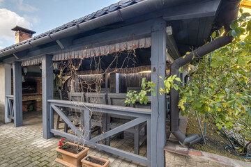 interior of empty hall veranda in wooden village vacation home with garden chairs