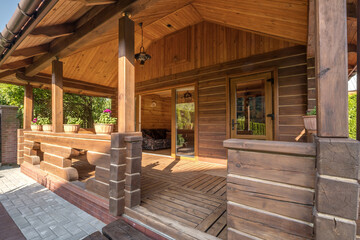 Fototapeta na wymiar interior of empty hall veranda in wooden village vacation home with garden chairs