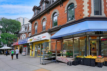 Fototapeta premium Toronto, Ontario, Canada - A row of stores and restaurants in the old Cabbagetown neighborhood with heritage architecture, preserved 19th century buildings
