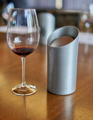 Malbec wineglass and a metal spittoon at a wine tasting. Selective focus