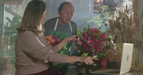 Businesswoman owner of flower shop delegating orders to employees. Staff of floriculture store...