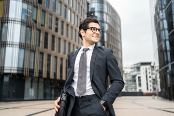 Businessman man with glasses goes to work in the office in a business suit