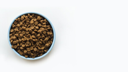 The blue pet bowl with dry food on white background with place for text