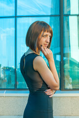 A beautiful girl poses in the business center.