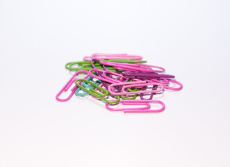 A group of colorful paper clips on isolated white background. Selective focus of paper clips.