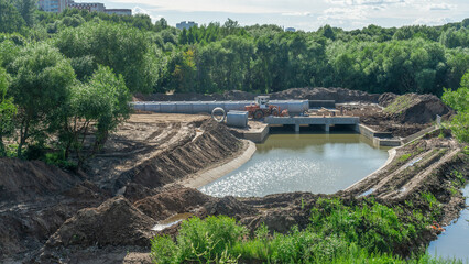 Construction of the river drains. Construction drains to prevent flooding in the city. Drain water into the river.
