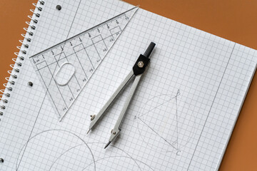 Close up Compass and ruler on the open notebook.  Mathematical accessories, back to school...
