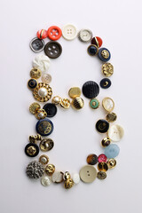 Bottoni di varie forme, colori e dimensioni isolati su fondo bianco