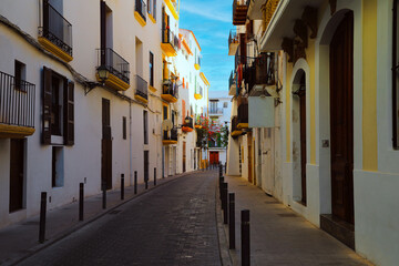 Fototapeta na wymiar Typical street of the old town of Ibiza Town, in Balearic Islands, Spain