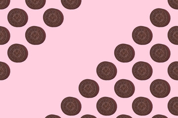Pattern of chocolate cookies. chocolate Cookies on a pink background. Flat lay. Sweet cookies flat lay pattern on light pink background. Top view...