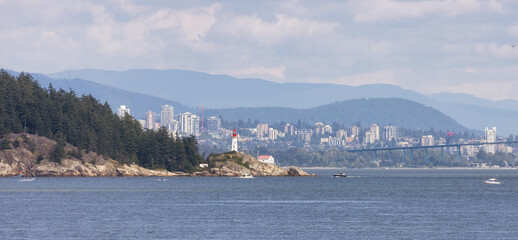 Lighthouse Park, Modern city in background during sunny summer day. West Vancouver, British Columbia, Canada.