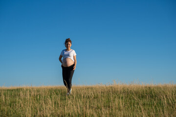 Pregnant woman walking in nature