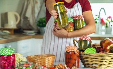 Woman jar preserve vegetables in the kitchen. Selective focus.