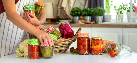 Woman jar preserve vegetables in the kitchen. Selective focus.