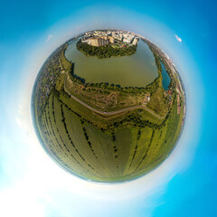 over the lake a racing track for cross-country motorcycles near the Kuban river and the western outskirts of the city of Krasnodar in the south of Russia - a small planet aerial panorama on a summer s - obrazy, fototapety, plakaty