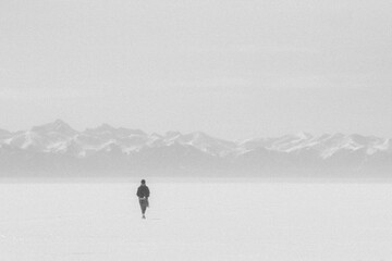 A man goes into the distance along the frozen lake Baikal