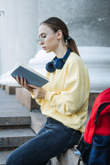 Positive daily affirmations for self love. Young woman in headphones writing in notebook