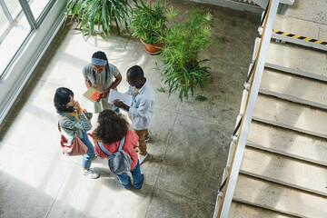 High angle view of group of students standing at corridor and preparing for the classes together