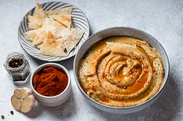 Traditional arabian eggplant dip baba ganoush with herbs and smoked paprika on light background. Eggplant hummus. Babaganush or eggplant caviar. Baked eggplant. Turkish eggplant dip
