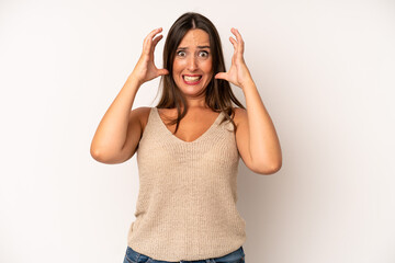 hispanic pretty woman screaming with hands up in the air, feeling furious, frustrated, stressed and...