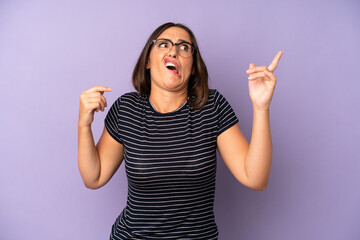 hispanic pretty woman shrugging with a dumb, crazy, confused, puzzled expression, feeling annoyed...