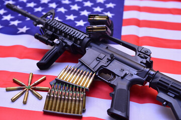 An American-made automatic carbine rifle over the US flag with stacks of ammunition rounds.  A...