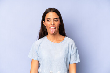 hispanic pretty woman feeling disgusted and irritated, sticking tongue out, disliking something...