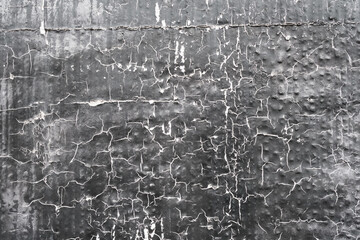 Grey peeling painted wall made of plaster, weathered textured surface, grunge texture background.