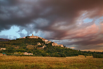 Trevi, Perugia, Umbria, Italy: landscape at sunset of the hill town under a dramatic cloudy sky