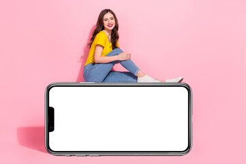 Full body profile portrait of cheerful charming girl sitting empty space blank isolated on pink color background