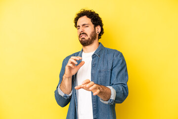 young bearded man feeling disgusted and nauseous, backing away from something nasty, smelly or...