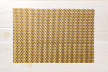 Fototapeta premium Top view of brown tablecloth for food on wooden background. Empty space for your design