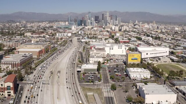 Aerial Time Lapse Shot Of Modern Buildings By Mountains, Drone Flying Forward Over Roads In City -  Los Angeles, California
