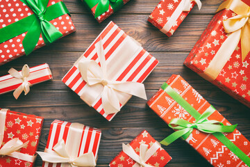 Obraz premium A lot of Christmas gift boxes in colored paper decorated on table, Top view close up. Many present New Year gift
