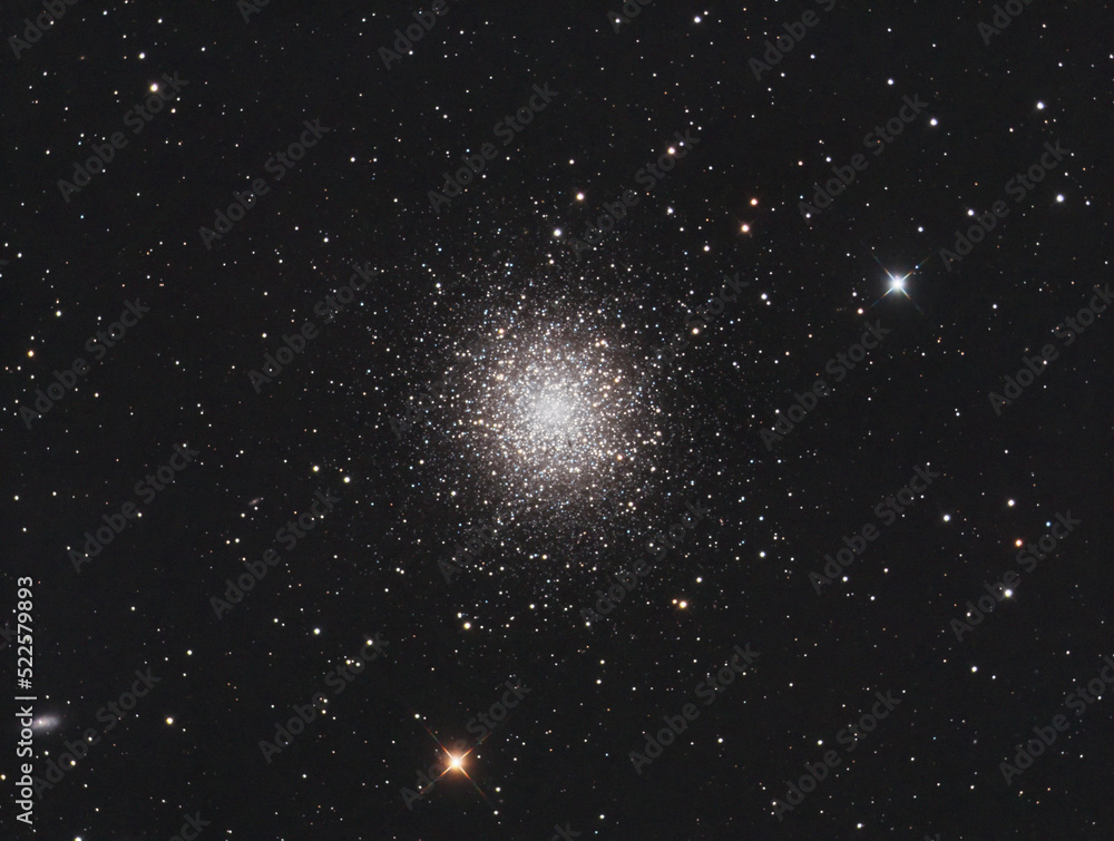 Wall mural messier 13 globular cluster in hercules constellation, with many stars as background and a galaxy on