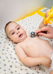 Hospital pediatric healthcare. Examining newborn baby with stethoscope.