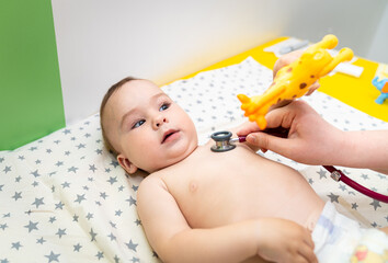 Examining newborn baby with stethoscope. Hospital pediatric healthcare.