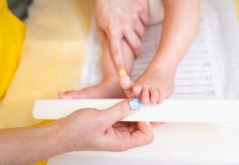 Obraz na płótnie Canvas Close up view examining baby feet. Small child pediatry.