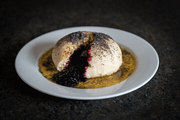 a austrian speciality are sweet dumplings with plum, melted butter and poppy