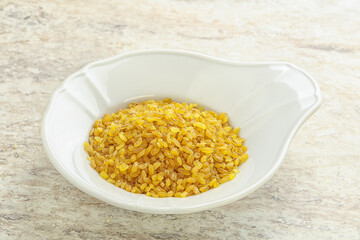 Raw bulgur in the bowl