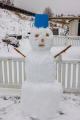 Beautiful view of snowman made by children in winter garden. Sweden.