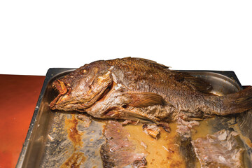 Close up view of stove baked grouper fish on tray isolated on white background. Healthy food concept. 