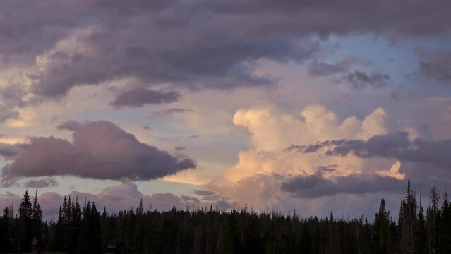 Timelapse of clouds at sunset over the Utah wilderness as sunlight fades into dusk.