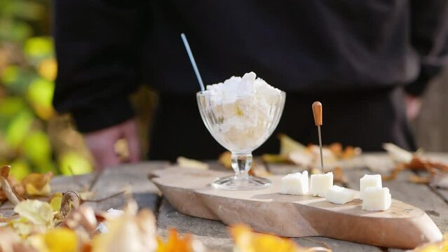 Man putting white goat cheese, feta and cottage cheese on table
